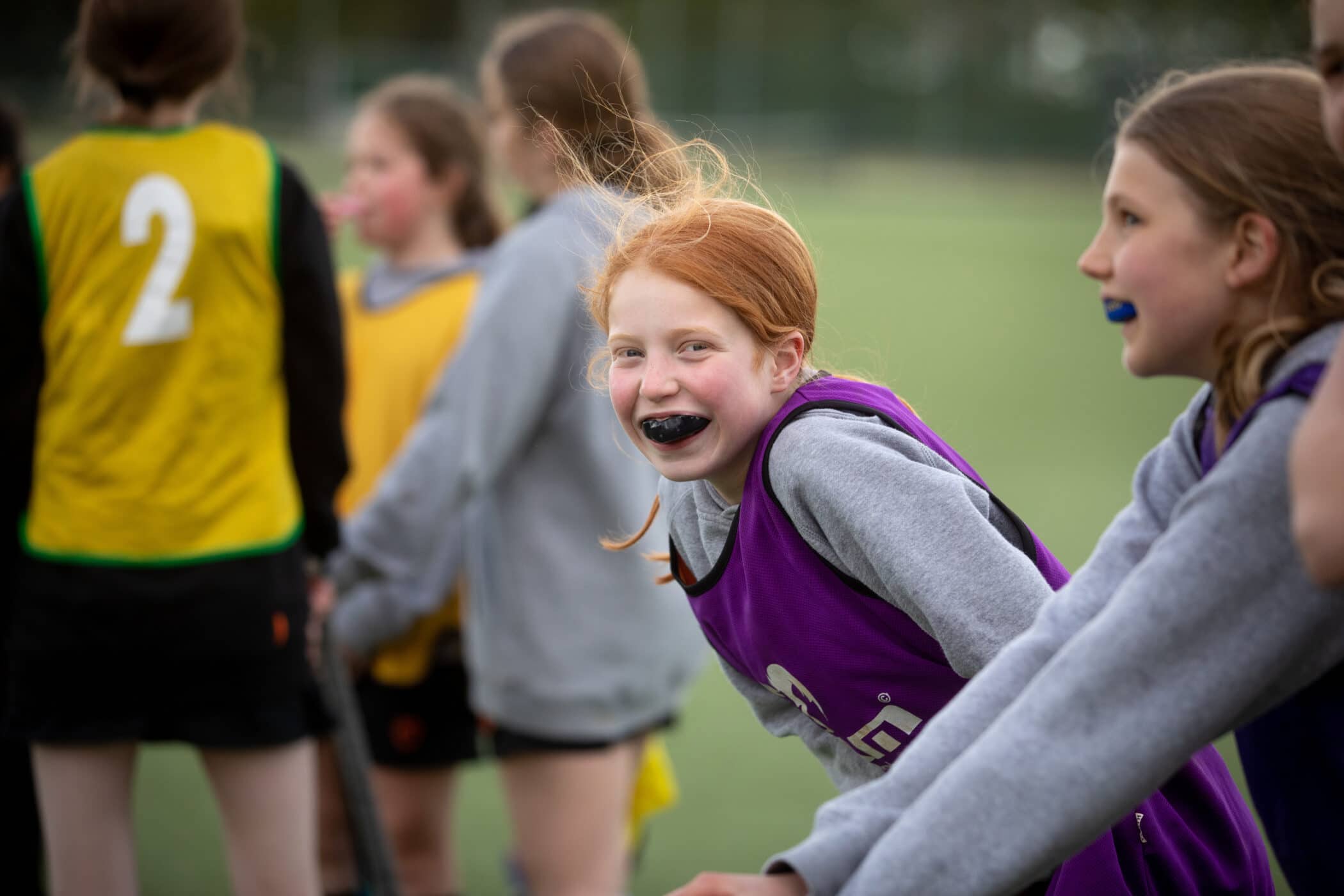Smiling child with gumshield playing hockey