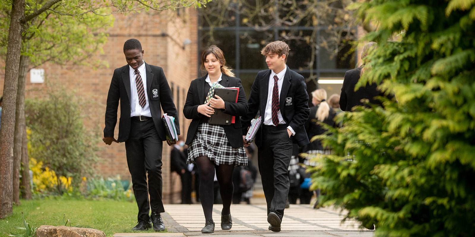 cheerful Bloxham students walking to class