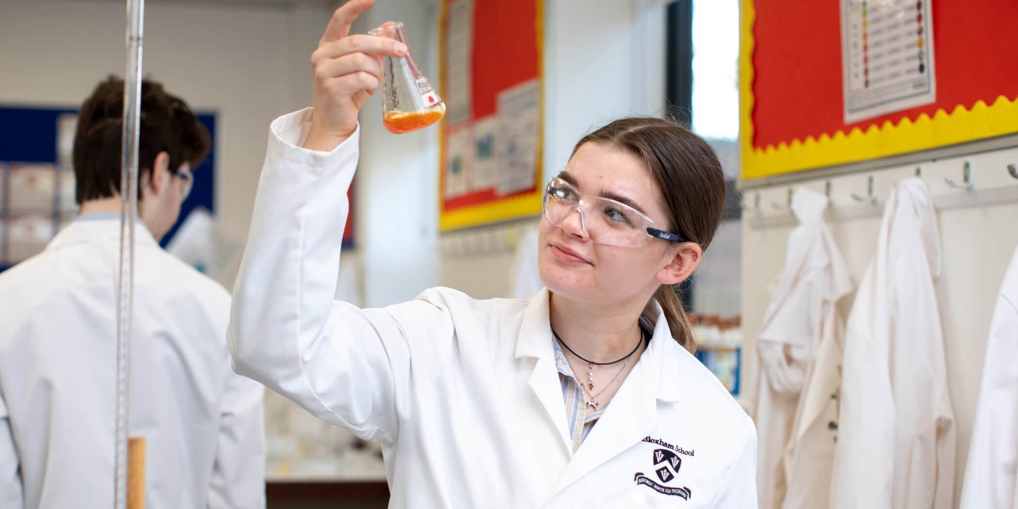 A Bursary Student doing chemistry in the science lab
