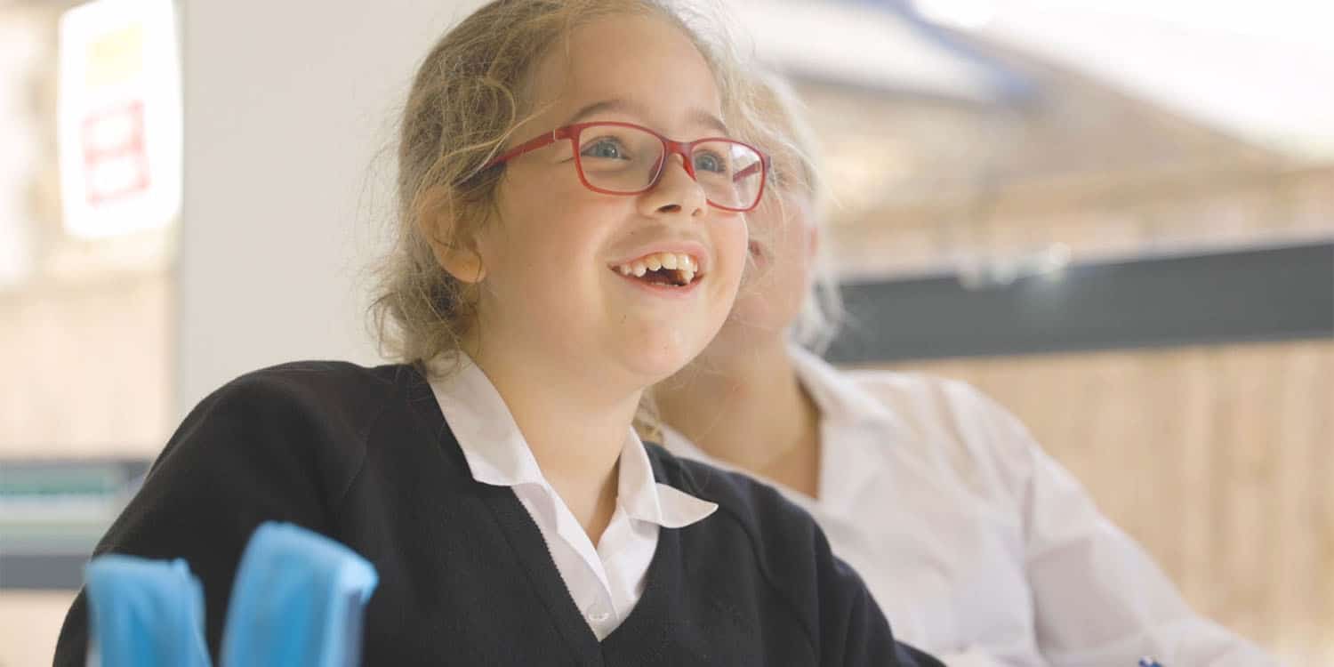 An excited lower school student in maths class