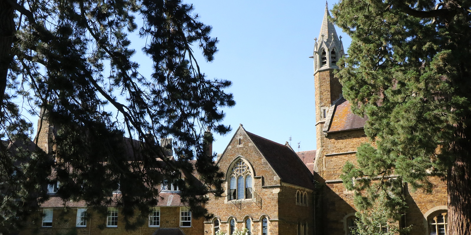 Bloxham School headmasters lawn and chapel in sun